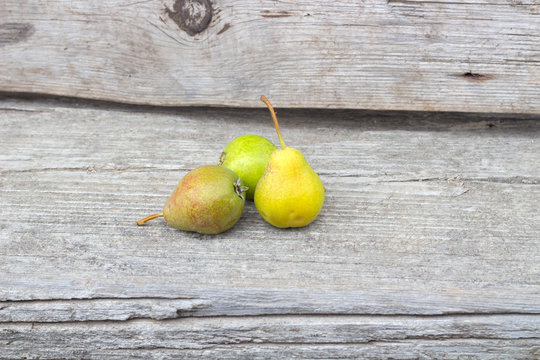 Small group of fresh natural pears on wooden texture