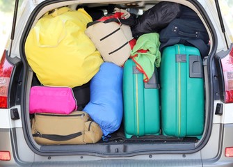 car and plenty of luggage and suitcases when leaving for family summer holidays