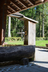 Old water well of wood in a forest