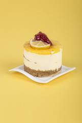 cake decorated with strawberry and lemon on yellow