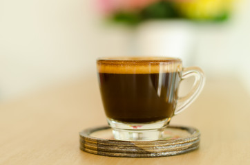 The cup of coffee on table