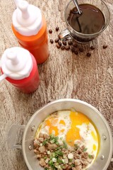 Breakfast with  fried eggs on pan and hot coffee