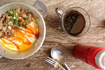 Breakfast with  fried eggs on pan and hot coffee