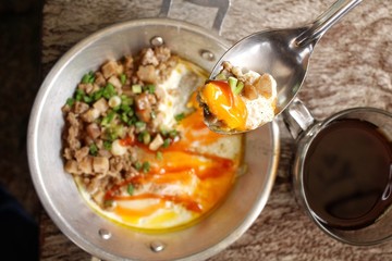 Breakfast with  fried eggs on pan and hot coffee