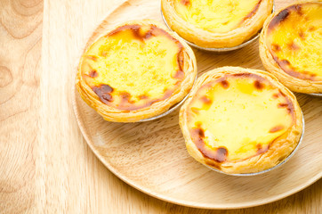 Egg tart on wooden plate