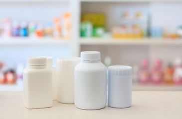 many medicine bottle with blur shelves of drug in the pharmacy d