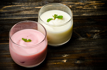 Homemade yogurt in the glass on wooden background