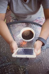 Fototapeta na wymiar Woman drinking hot coffee with tablet