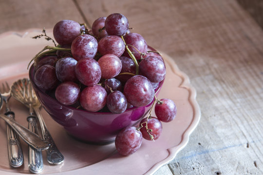 Fresh Red Grapes In A Purple Bowl