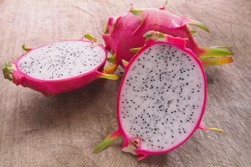 Dragon Fruit and some slice on old Wooden Table
