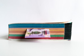 The Thai money inthe thick book isolated on white background.