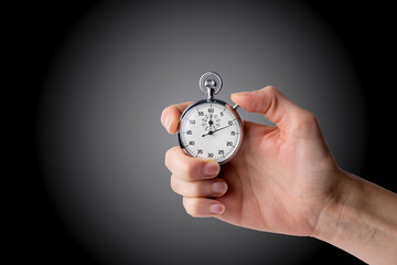 timer hold in hand, button pressed black/grey background