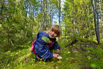 Adorable little girl hiking in the forest on summer day.
