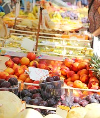 stand with basket full of seasonal fruits in the local market of