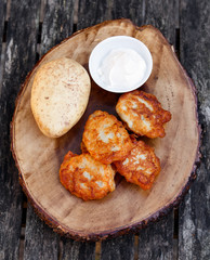 Fried potato pancakes wich soure cream on the old wooden background