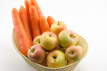 Carrots and apples in a basket.