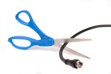 Scissors cutting through a coaxial RG6 cable - cut the cable tv concept isolated on white background