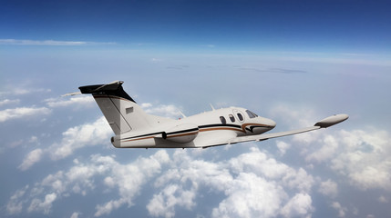 Rear view of a private jet flying