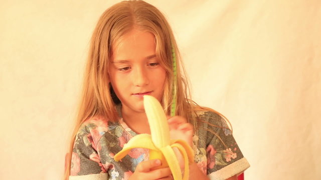 Cute girl eating banana