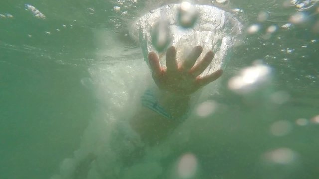 Young Woman Jumping and Diving into Sea. Slow Motion.