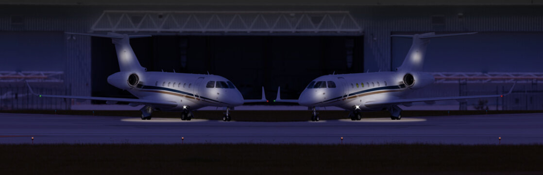 Two Private Planes In Front Of A Hangar At Night