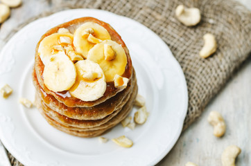 banana cashew pancakes with bananas and salted caramel sauce