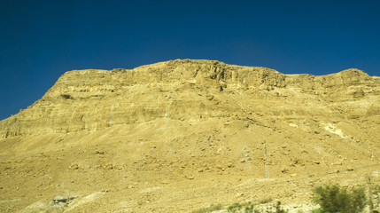 Yellow stones and mountains in Judean desert
