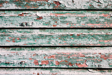 Painted texture of old wooden planks of green color. Weathered wooden plane.