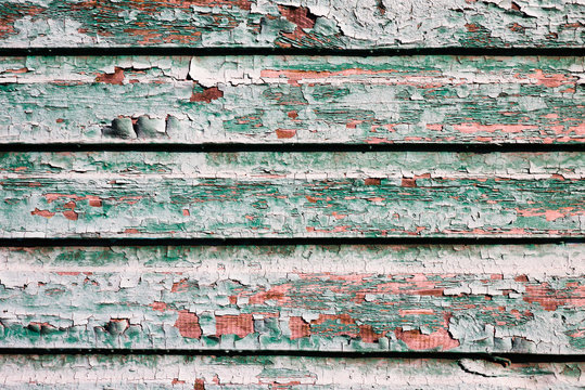 Painted texture of old wooden planks of green color. Weathered wooden plane.