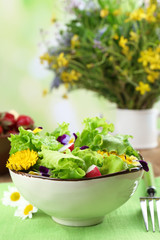 Light organic salad with flowers, close up