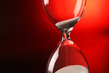 Hourglass on dark red background