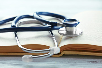 Stethoscope on open book close up