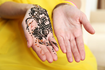 Image of henna on female hands, closeup