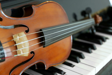 Violin on piano keys, closeup
