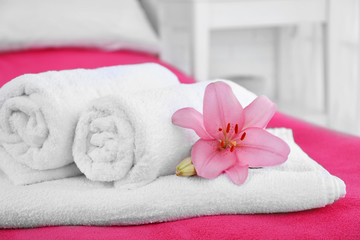 Freshly laundered fluffy towels in bedroom interior