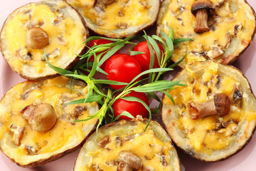 Baked potatoes with cheese and mushrooms on table close up