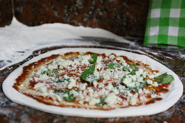 Preparing pizza on marble table, closeup