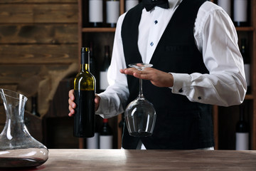 Bartender working at counter on bar background