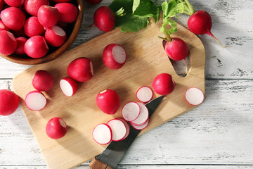 Fresh sliced radishes on cutting board close up