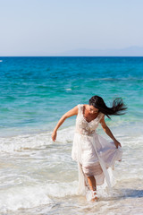 bride  in her snow-white dress on the beach