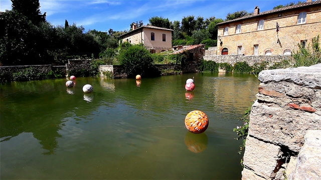 A timelapse clip at the tuscan village of Bagno Vignoni, near Siena, Tuscany, Italy, a thermal spring already known from the middle age, with an installation of floating balls
