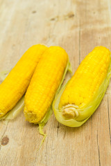 Fresh boiled corn on wooden background