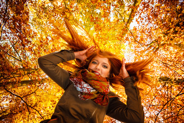 Unusual angle of young woman in autumn park