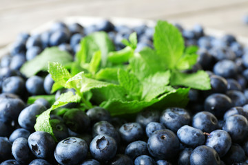 Heap of tasty ripe blueberries with mint close up