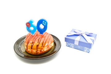 donut with sixty years birthday candle and gift
