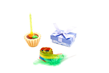 cake with yellow birthday candle, whistle and gift