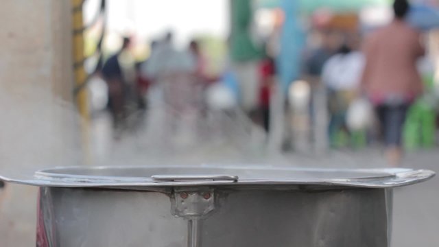 Boiling water in a big kitchen pot in the market