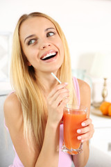 Young beautiful woman drinking fresh juice