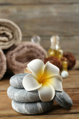 Stack of spa stones  and spa treatment on wooden background