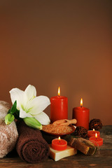Beautiful spa composition with lily on brown background